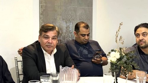 A group of men sitting at a table

AI-generated content may be incorrect.