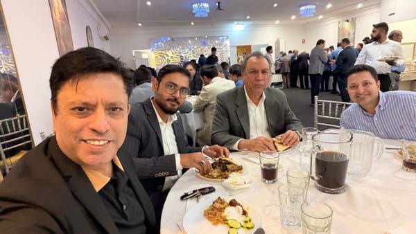 A group of men sitting at a table with food

AI-generated content may be incorrect.