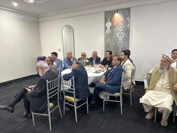 A group of people sitting around a table

AI-generated content may be incorrect.