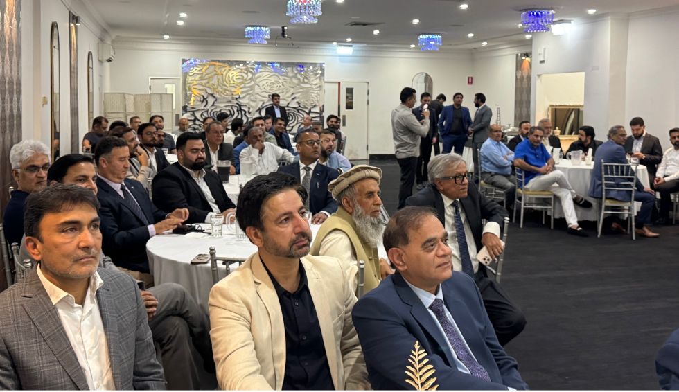 A group of people sitting in a room

AI-generated content may be incorrect.