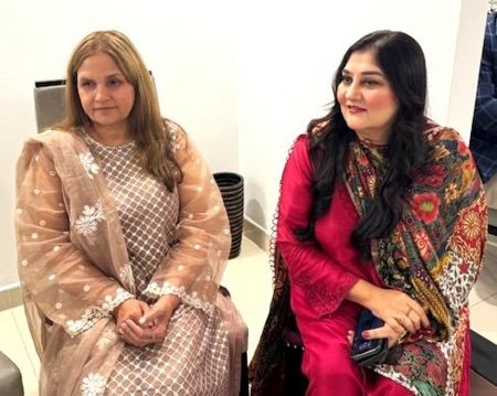 Two women sitting in a room

AI-generated content may be incorrect.