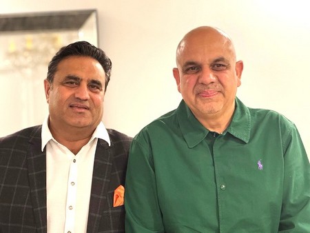Two men standing together smiling

AI-generated content may be incorrect.