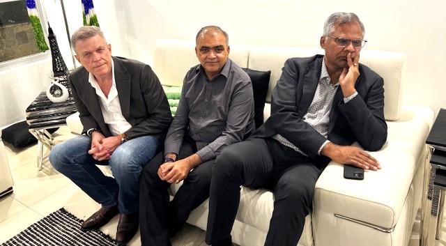 A group of men sitting on a couch

AI-generated content may be incorrect.