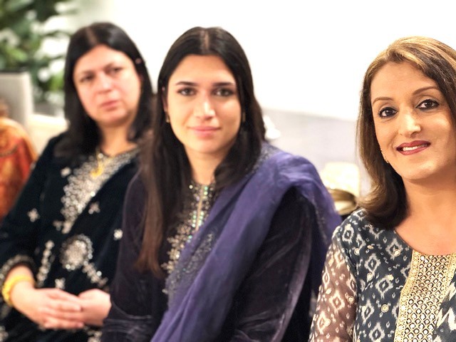 A group of women smiling

AI-generated content may be incorrect.