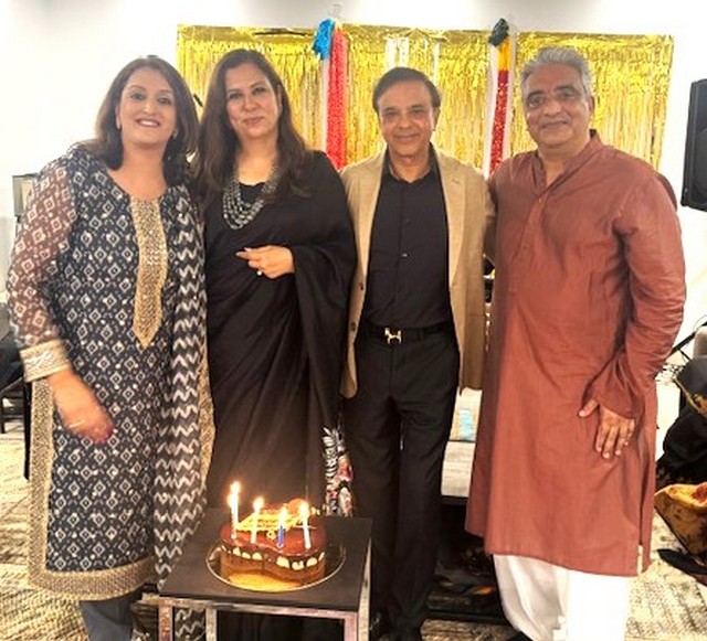 A group of people standing in front of a cake

AI-generated content may be incorrect.