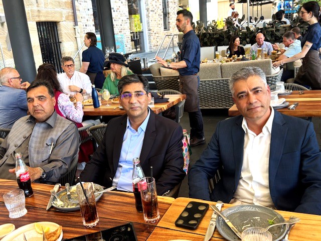 A group of men sitting at a table

AI-generated content may be incorrect.