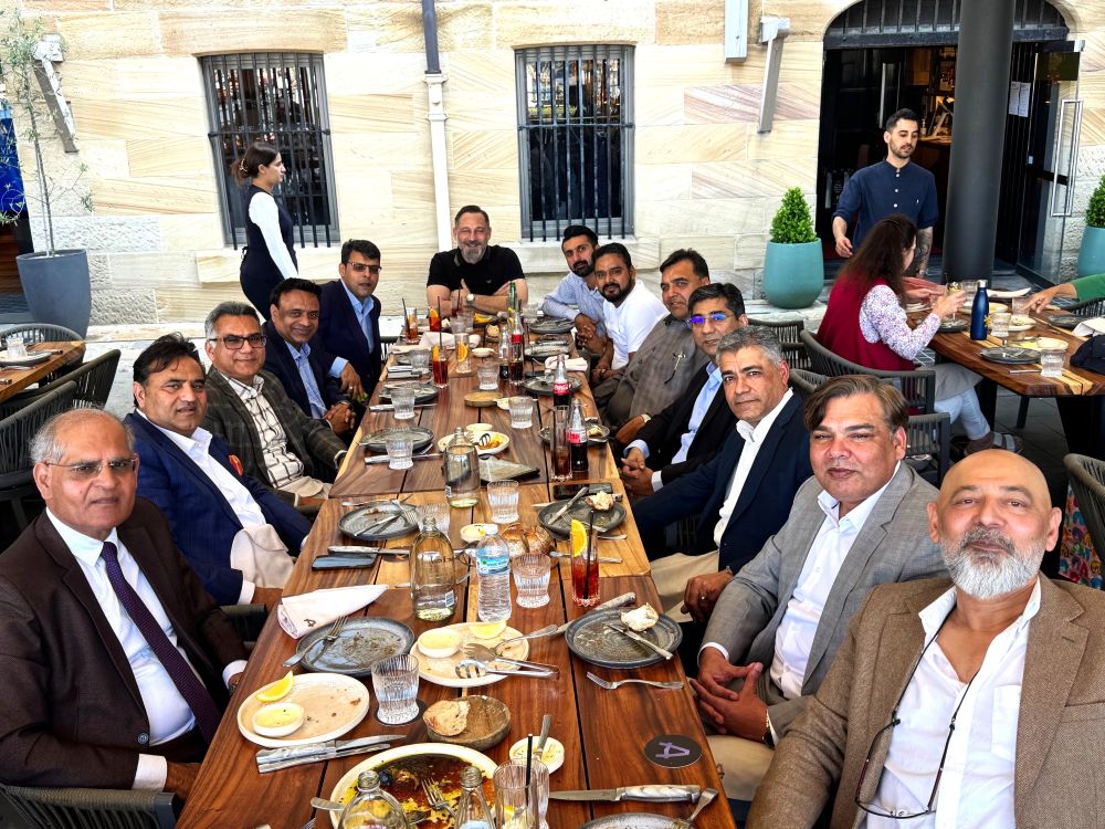 A group of people sitting around a table

AI-generated content may be incorrect.