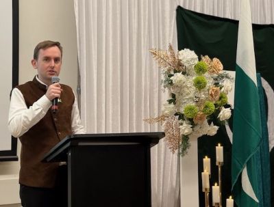 A person standing at a podium speaking into a microphone

AI-generated content may be incorrect.