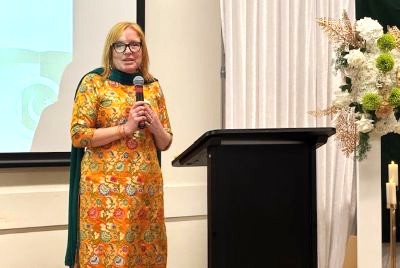 A person standing in front of a podium holding a microphone

AI-generated content may be incorrect.