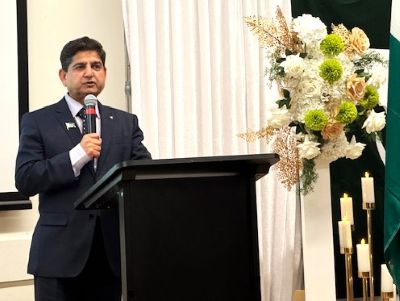 A person standing at a podium with a microphone

AI-generated content may be incorrect.