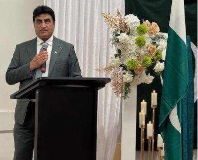 A person standing at a podium with a microphone

AI-generated content may be incorrect.