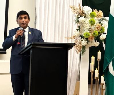 A person standing at a podium with a microphone

AI-generated content may be incorrect.