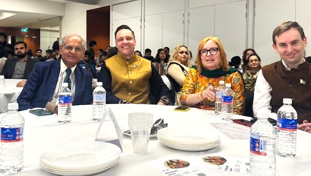 A group of people sitting at a table

AI-generated content may be incorrect.