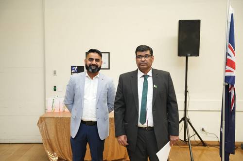 Two men standing in front of a table

AI-generated content may be incorrect.