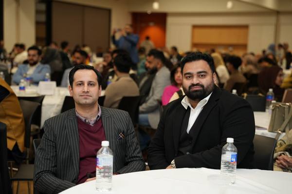 A group of men sitting at a table

AI-generated content may be incorrect.