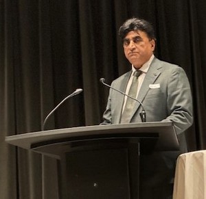 A person standing at a podium with microphones

AI-generated content may be incorrect.