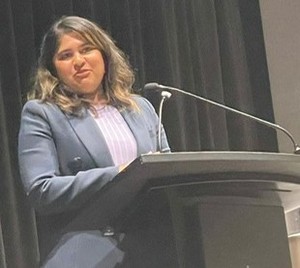 A person standing at a podium

AI-generated content may be incorrect.