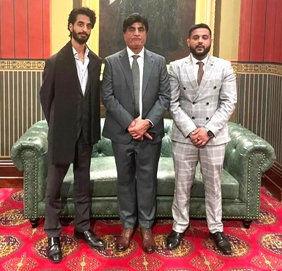 A group of men standing in front of a couch

AI-generated content may be incorrect.