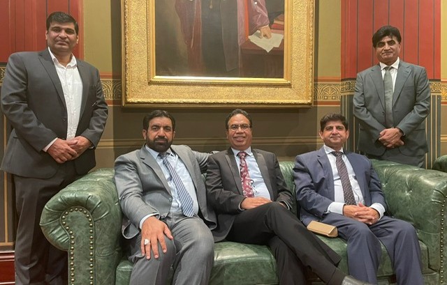 A group of men sitting on a couch

AI-generated content may be incorrect.