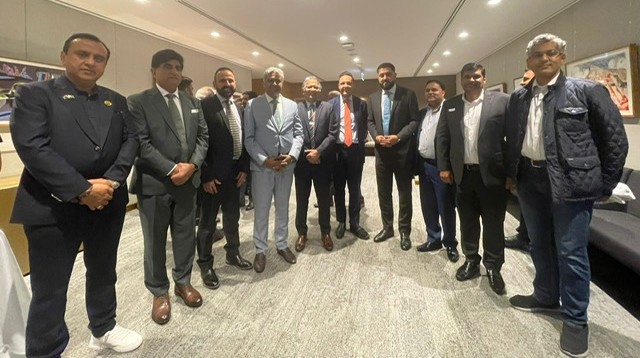 A group of men standing in a room

AI-generated content may be incorrect.