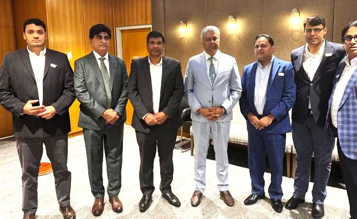 A group of men standing in a room

AI-generated content may be incorrect.