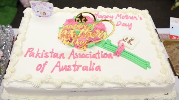 A cake with pink and green decorations

AI-generated content may be incorrect.