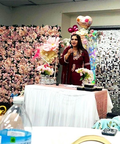 A person standing at a table with flowers

AI-generated content may be incorrect.