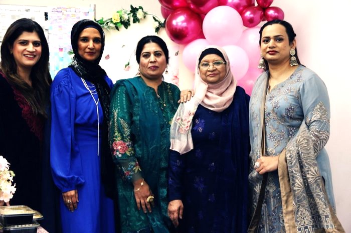 A group of women standing together

AI-generated content may be incorrect.