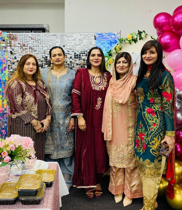 A group of women posing for a photo

AI-generated content may be incorrect.