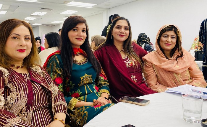 A group of women sitting at a table

AI-generated content may be incorrect.