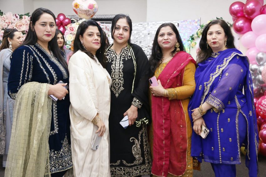 A group of women posing for a photo

AI-generated content may be incorrect.