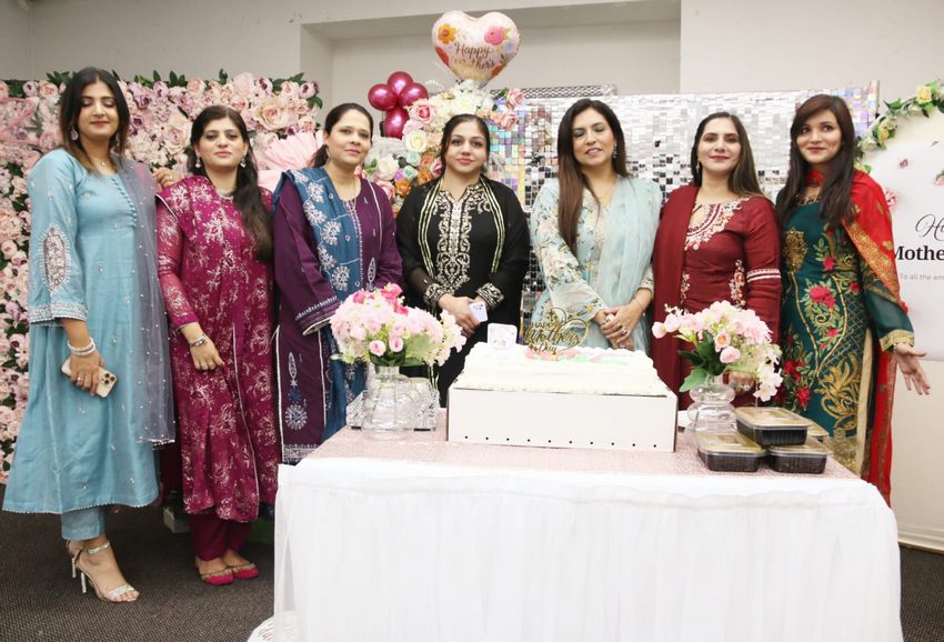 A group of women standing in front of a table with flowers

AI-generated content may be incorrect.
