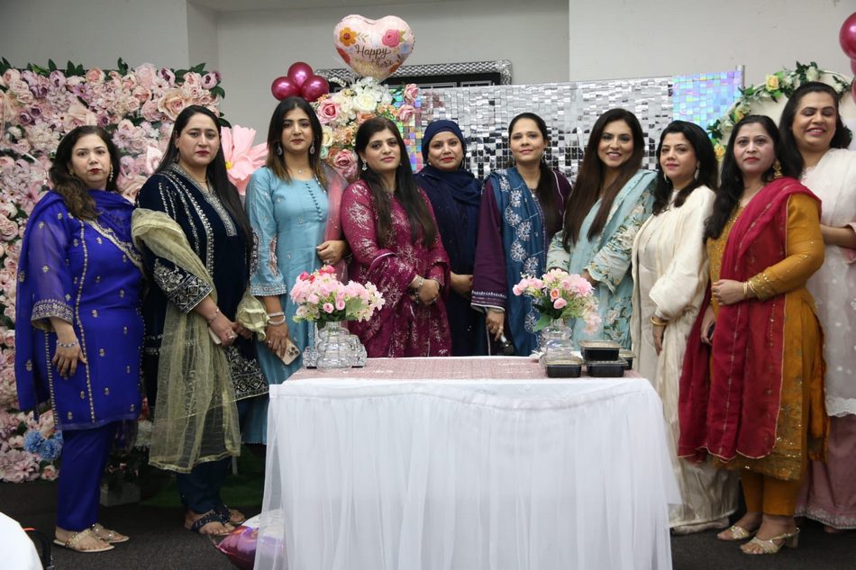 A group of women standing in front of a table

AI-generated content may be incorrect.