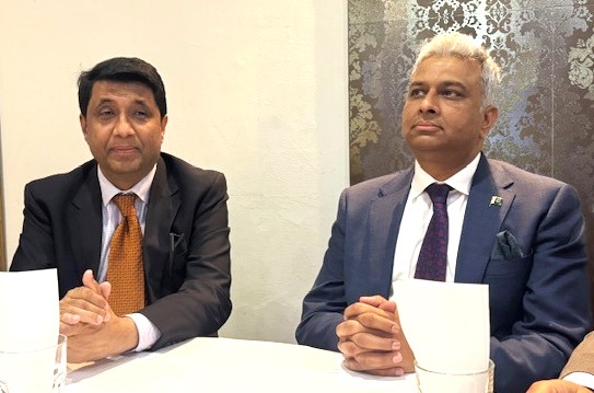 A couple of men sitting at a table

AI-generated content may be incorrect.