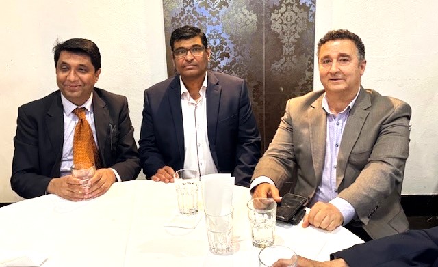 A group of men sitting at a table

AI-generated content may be incorrect.