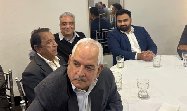 A group of men sitting at a table

AI-generated content may be incorrect.