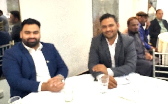 A group of men sitting at a table

AI-generated content may be incorrect.