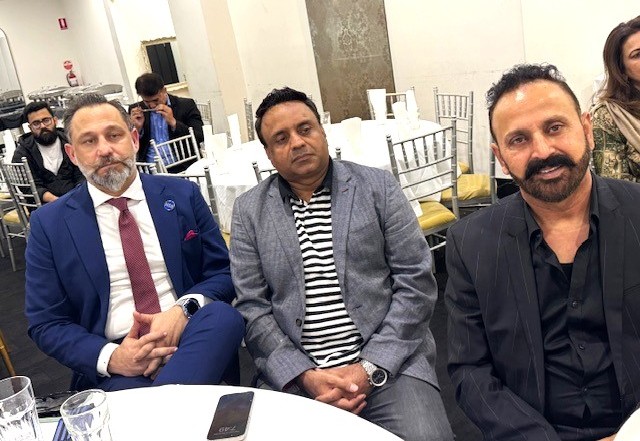 A group of men sitting at a table

AI-generated content may be incorrect.