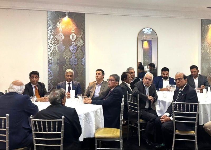 A group of men sitting around a table

AI-generated content may be incorrect.