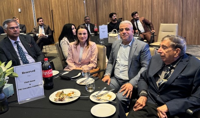 A group of people sitting at a table

AI-generated content may be incorrect.