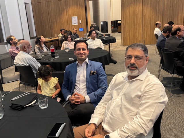 A group of men sitting at tables

AI-generated content may be incorrect.