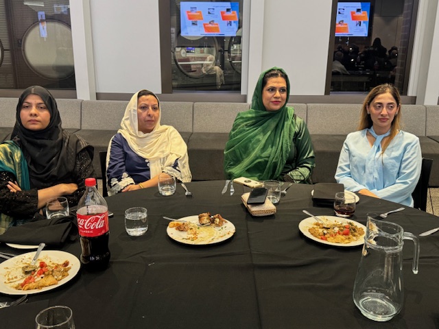 A group of women sitting at a table with plates of food

AI-generated content may be incorrect.