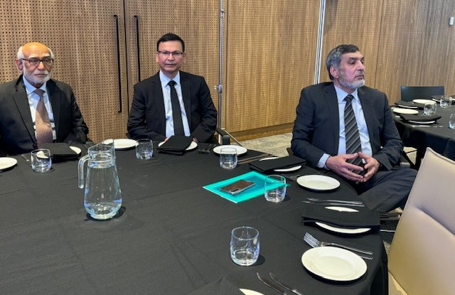 A group of men sitting at a table

AI-generated content may be incorrect.