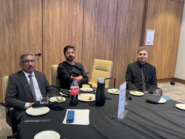 A group of men sitting at a table

AI-generated content may be incorrect.