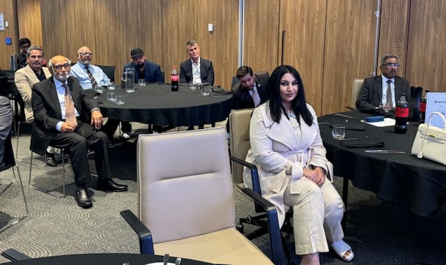 A group of people sitting around a table

AI-generated content may be incorrect.