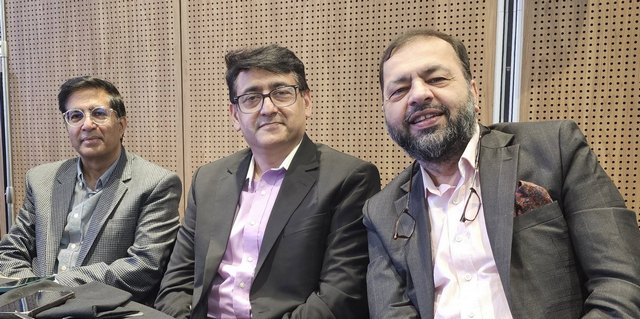 A group of men sitting together smiling

AI-generated content may be incorrect.