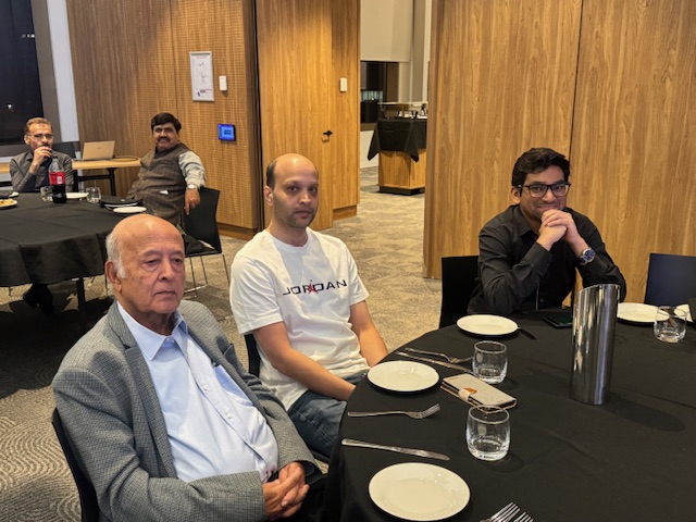 A group of men sitting at a table

AI-generated content may be incorrect.