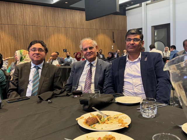 A group of men sitting at a table with plates of food

AI-generated content may be incorrect.