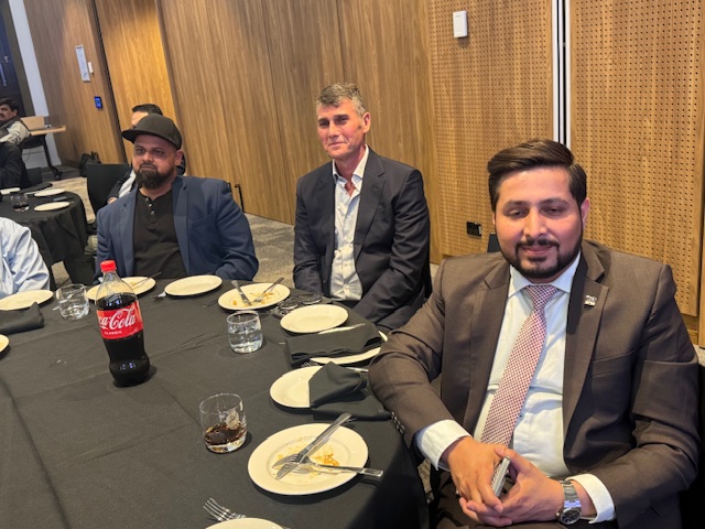 A group of men sitting at a table

AI-generated content may be incorrect.