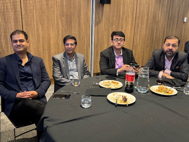 A group of men sitting at a table

AI-generated content may be incorrect.